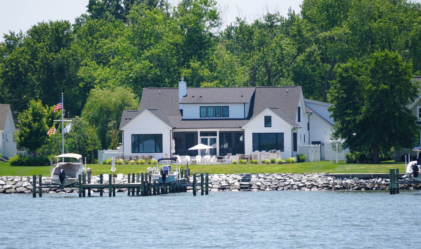 Waterfront home with a private dock and Maryland flag along the river in Severna Park, MD
